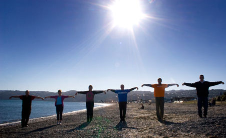 People practicing Qigong on the beach near Wellington, New Zealand